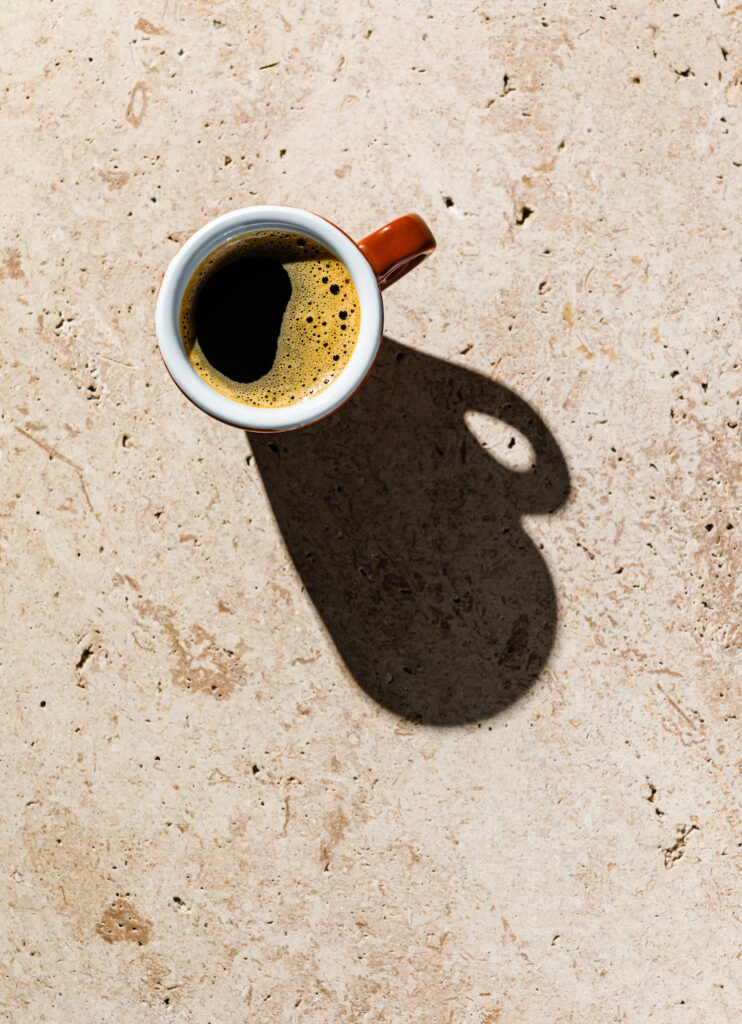Espresso coffee on beige stone background